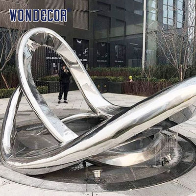 Large geometric circular fountain stainless steel sculpture in the square